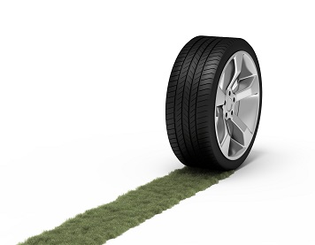 Green trace from a wheel. Ecological concept.